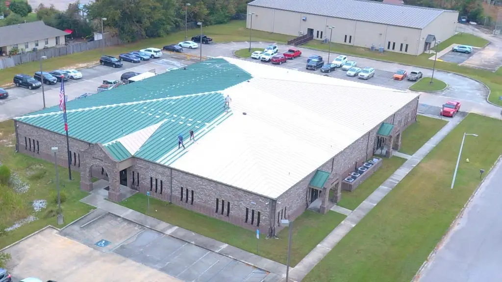 Roof Coating a commercial metal roof in Gulfport by Expert Roofing